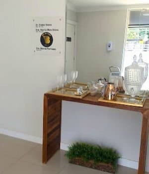 Recepção de clínica odontológica bem iluminada e organizada.